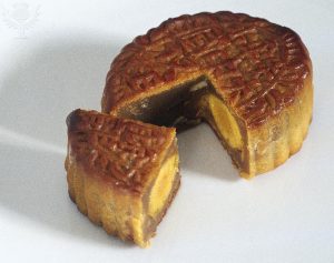 This is a Singaporean mooncake with a piece cut out to showcase the duck egg filling. Photo taken from Encyclopædia Britannica ImageQuest.