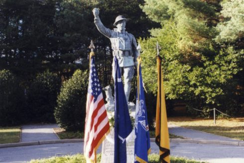 WWI Doughboy statue with flags