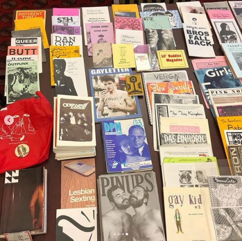 Queer Zines laid on a table with their covers showing