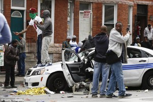 "Carnage: During the riots in the wake of Freddie Gray's death, police cars were left abandoned and burned out in the middle of the street while protesters jumped on them"